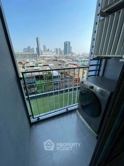 Charming balcony with city view and washing machine, perfect for urban living convenience.