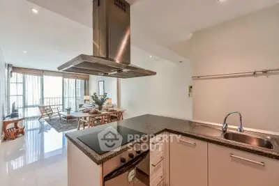Modern open-plan kitchen and dining area with sleek design and natural light.