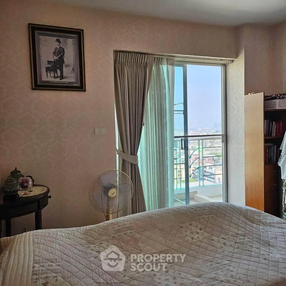 Cozy bedroom with balcony offering stunning city view