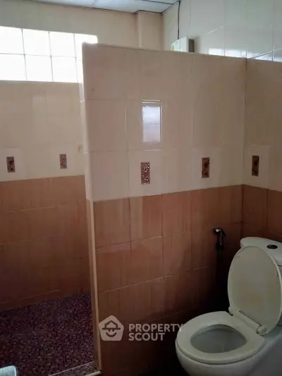 Spacious bathroom with tiled walls and modern fixtures