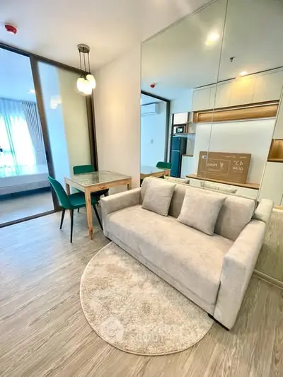 Modern living room with stylish decor and cozy seating in a contemporary apartment.