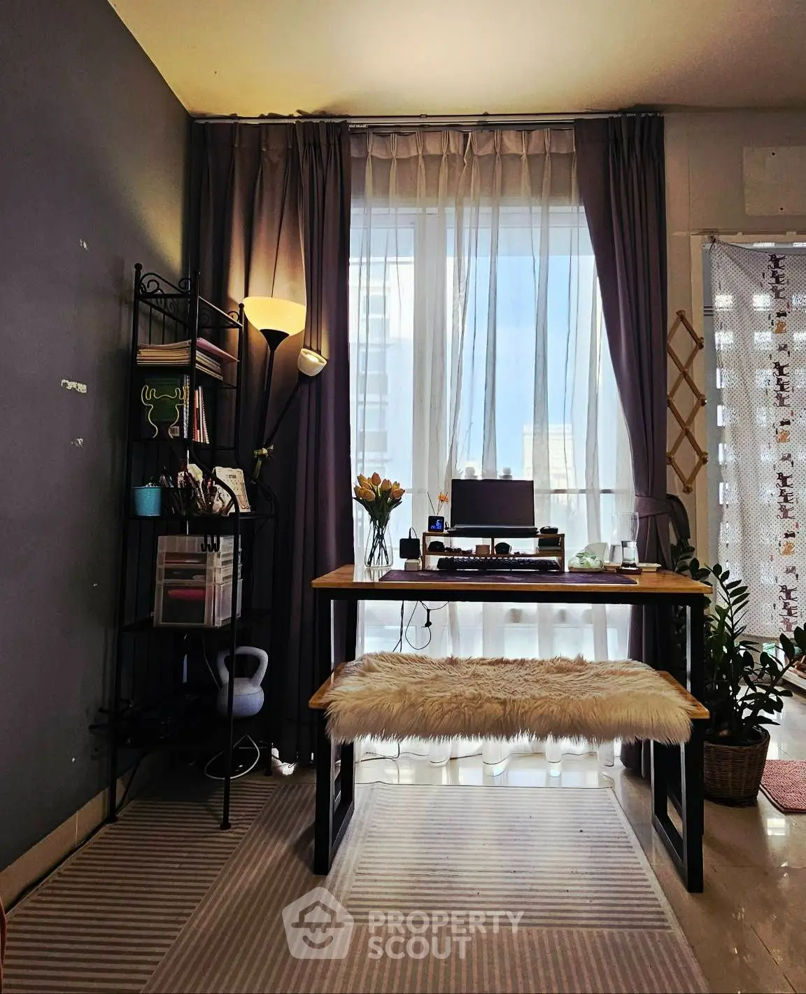 Chic study area with natural light, modern desk, and cozy decor.
