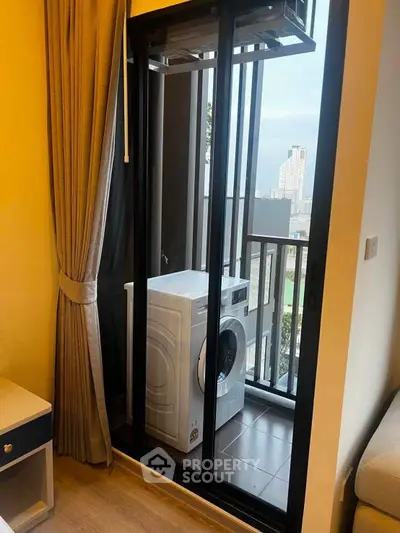 Modern apartment with balcony featuring a washing machine and city view.