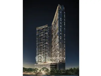 Stunning night view of modern high-rise residential building with illuminated windows and sleek architecture.
