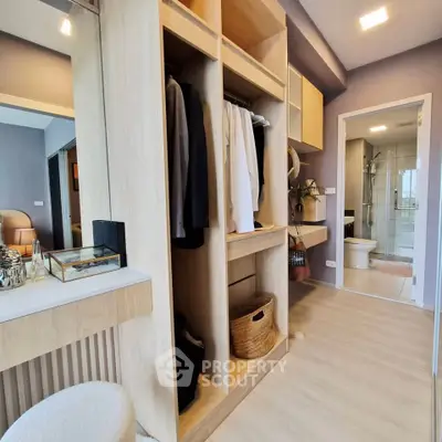 Spacious bedroom with walk-in closet and modern bathroom in luxury apartment