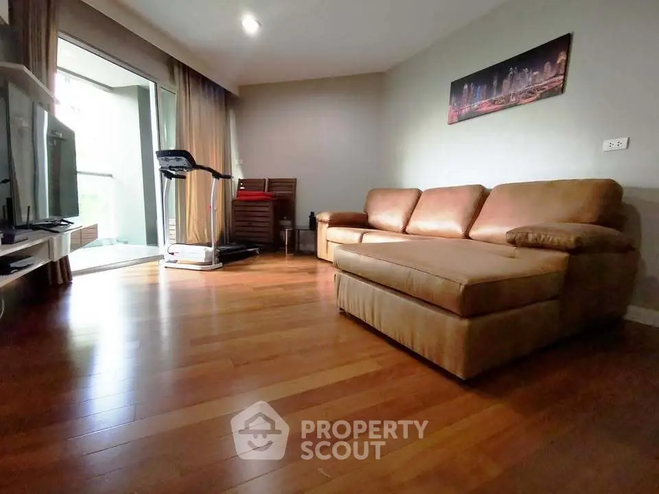 Spacious living room with hardwood floors and modern decor in a luxury apartment.