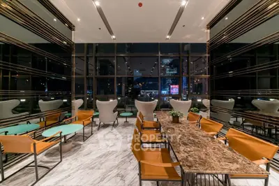Luxurious modern interior with marble flooring and city view, perfect for sophisticated gatherings.