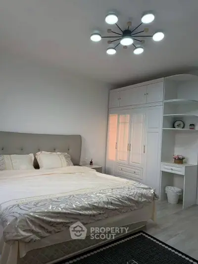 Cozy bedroom with modern lighting and spacious wardrobe, perfect for relaxation and comfort.