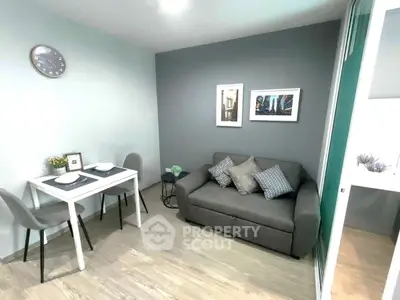 Chic modern living room with cozy sofa and dining area, perfect for urban living.