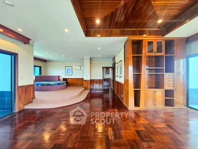 Luxurious living room with elegant wood flooring and built-in shelving, perfect for stylish entertaining.