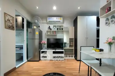 Modern living room with sleek furniture and open kitchen layout, perfect for urban living.