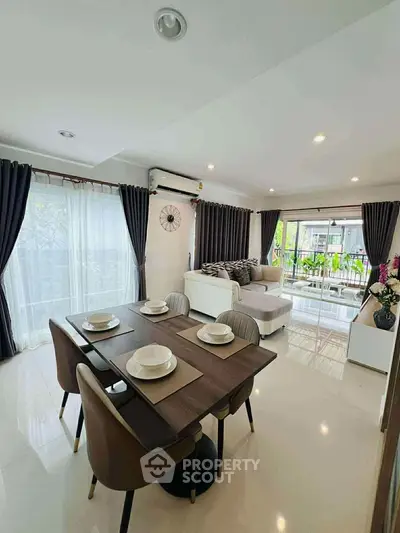 Spacious modern living room with elegant dining area and large windows.