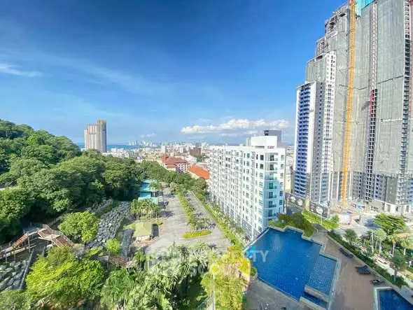Stunning cityscape view with modern high-rise buildings and lush greenery.