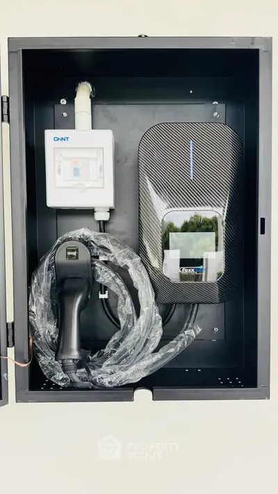 Modern electric vehicle charging station in sleek black casing, perfect for eco-friendly homes.