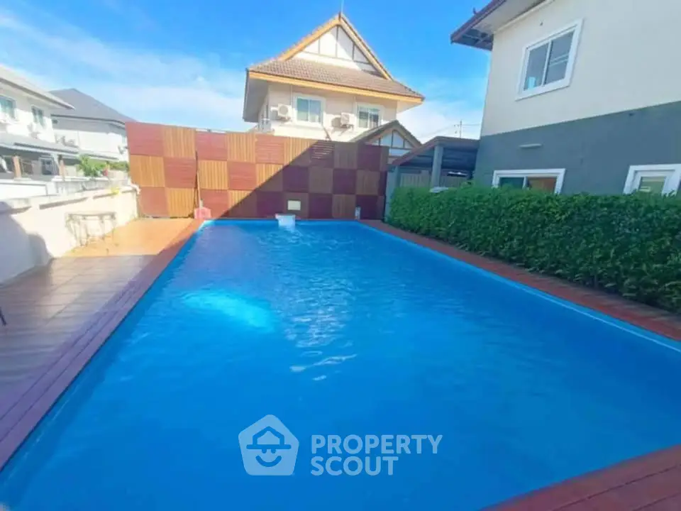 Stunning residential pool area with modern design and lush greenery.