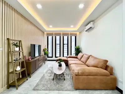 Modern living room with stylish decor, cozy sofa, and elegant lighting in a contemporary home.