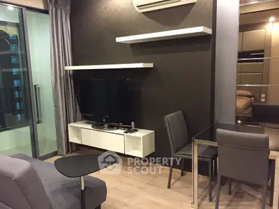 Modern living room with sleek furniture and balcony access in stylish apartment.