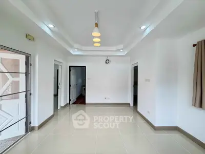 Spacious and bright living room with modern lighting and tiled flooring