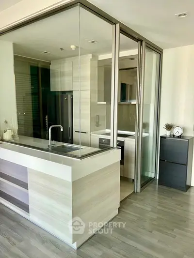 Modern kitchen with sleek glass partitions and stylish cabinetry