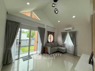 Spacious living room with modern design and large windows for natural light.