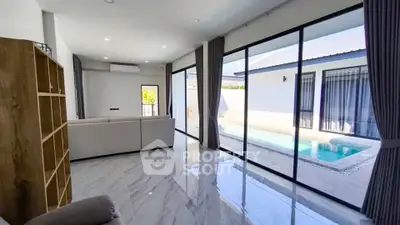 Modern living room with pool view and sleek interior design