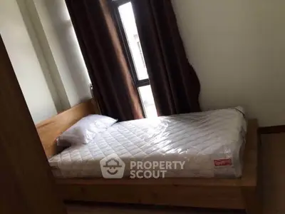 Cozy bedroom with single bed and window, perfect for a peaceful retreat.