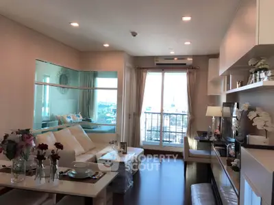Modern living room with balcony view, stylish decor, and natural light