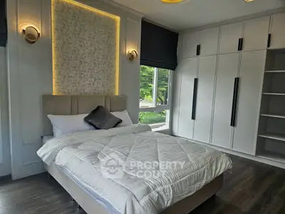 Luxurious bedroom with elegant decor and large window offering serene views.
