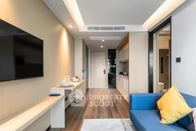 Modern living room with sleek design, open kitchen layout, and cozy seating area in a stylish apartment.