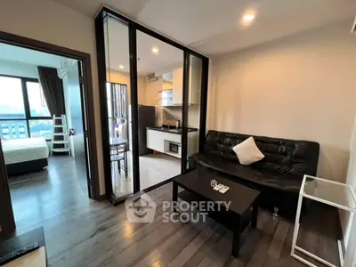 Modern apartment interior with open layout, featuring cozy living room and sleek kitchen design.