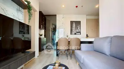 Modern living room with stylish decor and open layout, featuring a cozy sofa and elegant dining area.