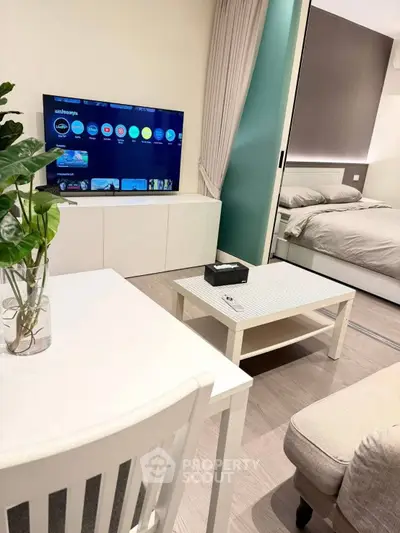 Modern studio apartment with sleek design, featuring a cozy living area and stylish bedroom.