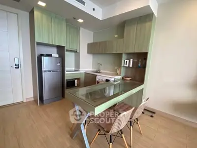 Modern kitchen with sleek cabinetry and integrated appliances in a stylish apartment.