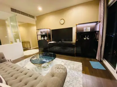 Luxurious living room with elegant decor and large TV, perfect for relaxation and entertainment.