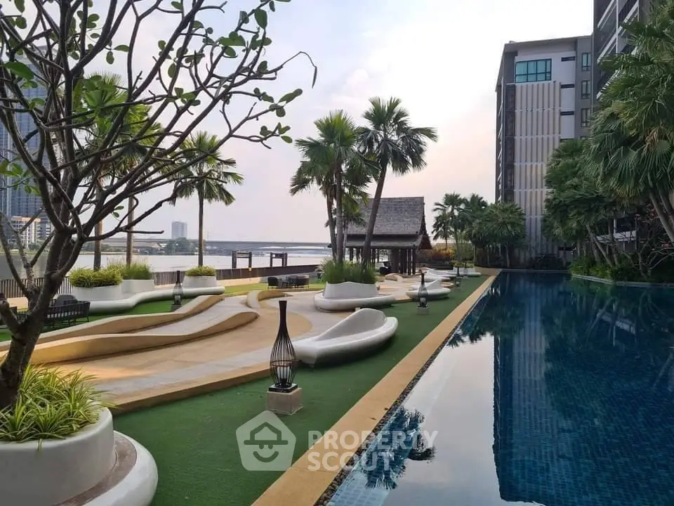 Luxurious riverside pool with lush landscaping and modern architecture