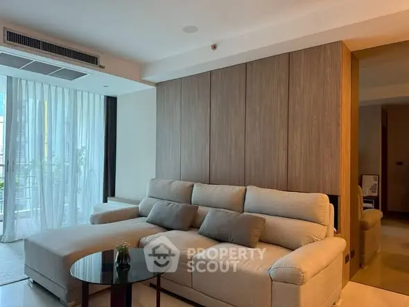 Spacious modern living room with large sofa and natural light