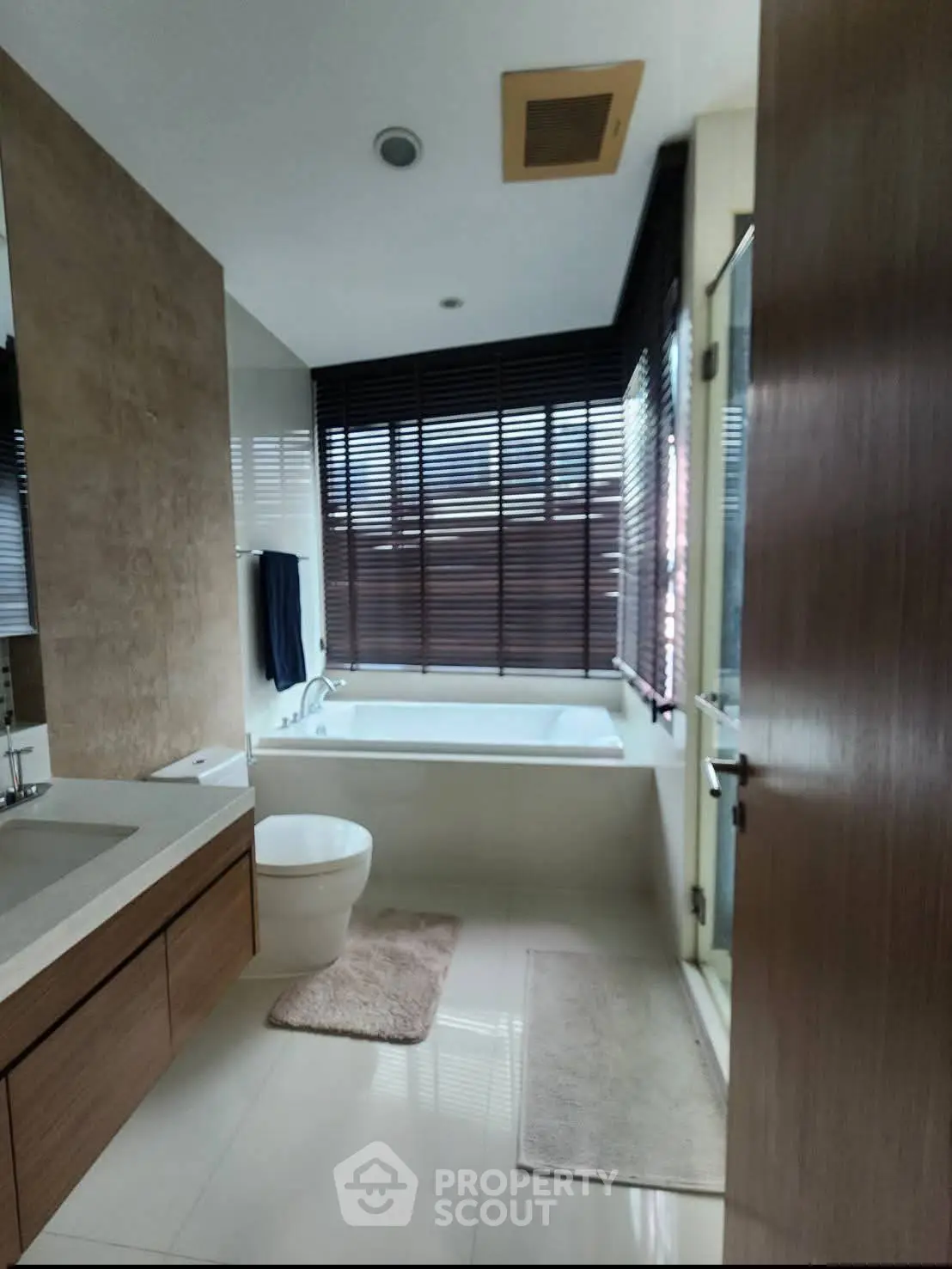 Luxurious bathroom with modern fixtures and large window for natural light.