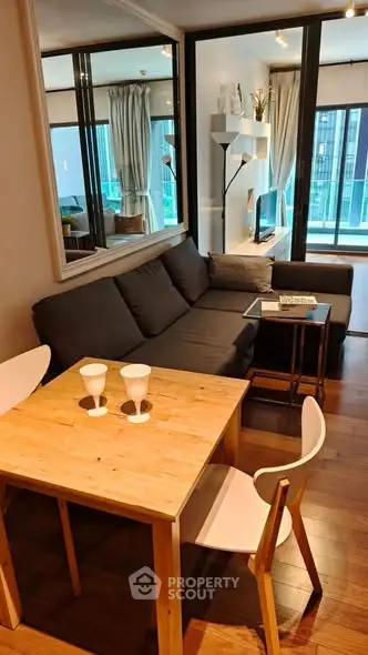 Modern living room with cozy sofa and dining area in stylish apartment