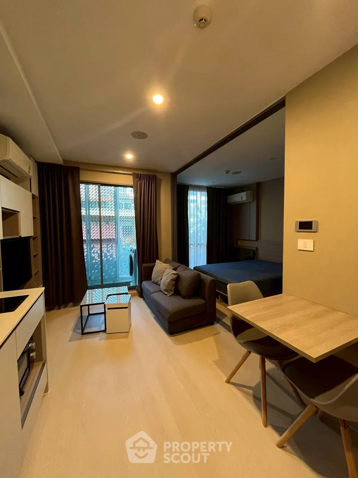 Modern living room with open layout and cozy furniture in a stylish apartment.