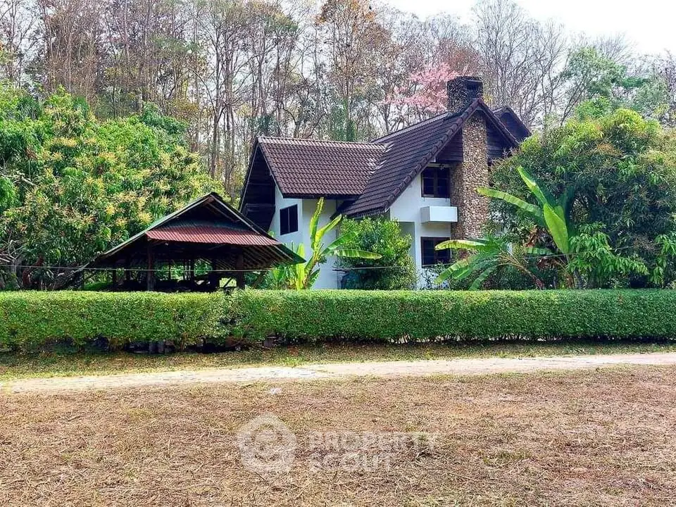 Charming countryside house with lush greenery and rustic architecture, perfect for nature lovers seeking tranquility.