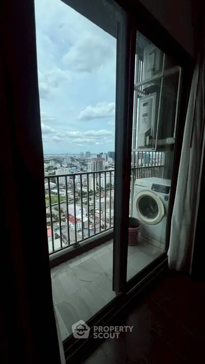 High-rise apartment balcony with stunning city view and washing machine