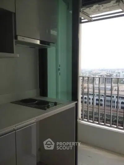 Modern kitchen with sleek design and balcony view in urban apartment