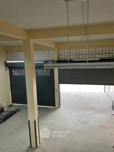 Spacious garage with roller doors and ample storage potential.
