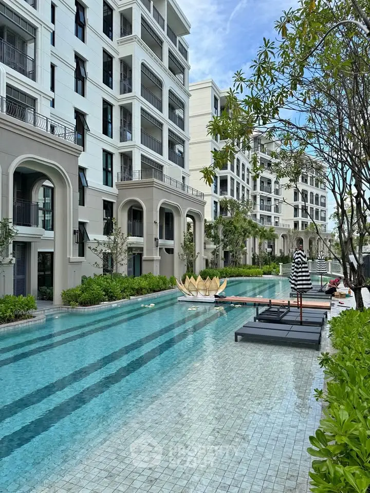 Luxurious apartment complex with stunning pool and lush greenery
