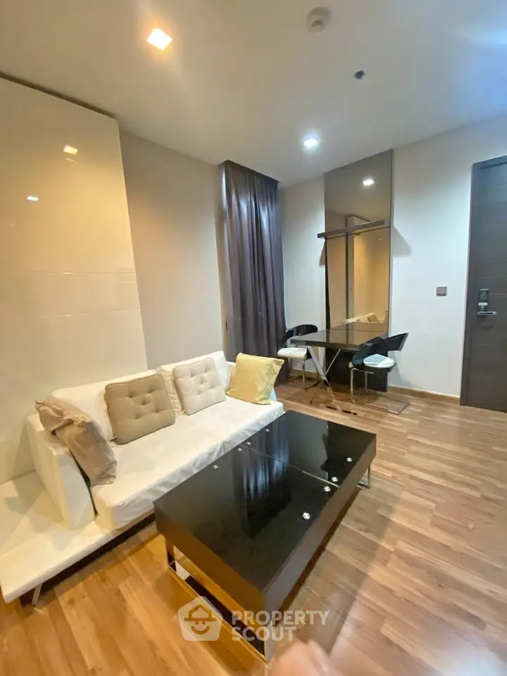 Modern living room with sleek furniture and wooden flooring