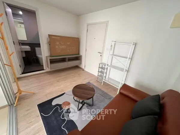 Modern living room with stylish decor and adjacent bathroom