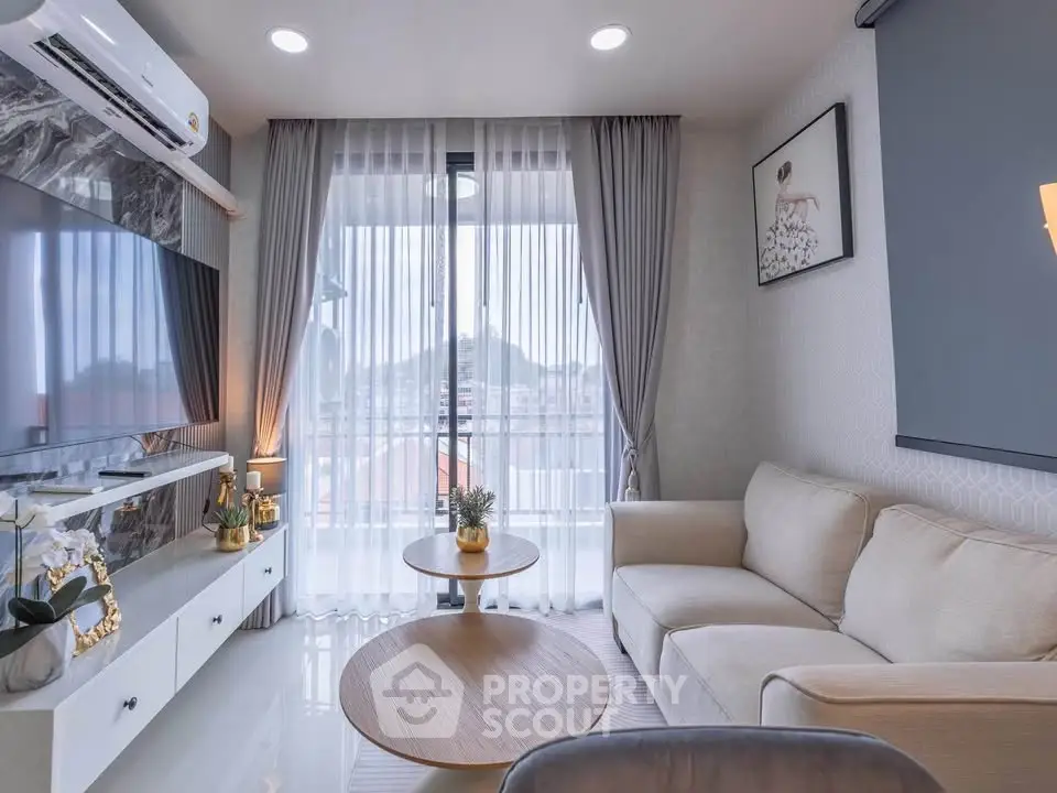 Modern living room with elegant decor, large window, and cozy seating area.