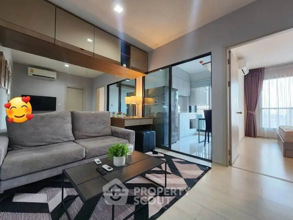Modern living room with stylish decor and open layout leading to bedroom