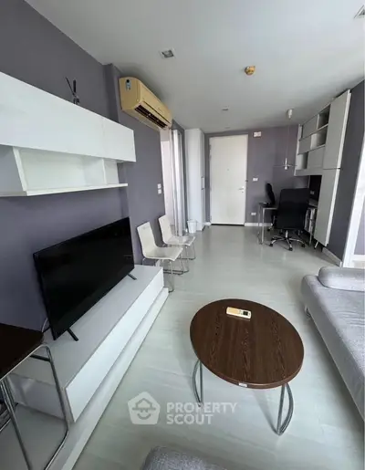 Modern living room with sleek furniture and air conditioning in a stylish apartment.