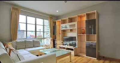 Modern living room with large window and stylish entertainment center